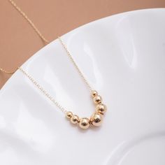 "14K Real Gold Ball Bead Chain Sparkle Necklace, Dainty Gold Choker, Minimalist Simple Ball Necklace, 7 Shiny Bead Necklace, Gifts For Women This necklace has 7 balls with 4 different sizes. The balls are 3mm - 6mm in diameter. The balls are hollow. 📘 D E T A I L S * Solid Gold (real gold, no gold-filled or no gold plated material) * Karat: 14 K (585) * Gold color: Yellow, rose, and white * Ball diameter: 3-6 mm * You can customize the chain length from 14\" to 22\". The \"cable chain\" is used Minimalist Polished Bead Necklace For Everyday, Gold Ball Necklace, Rose Gold Anklet, Custom Diamond Rings, Popular Necklaces, Sparkle Necklace, Golden Necklace, Monogram Ring, Summer Bracelets