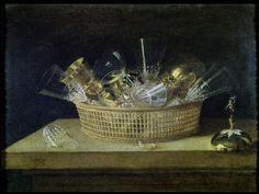 a basket filled with lots of silverware sitting on top of a wooden table next to a