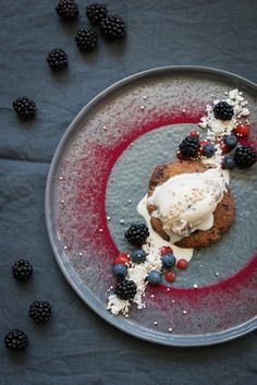 a dessert with berries and ice cream on a plate