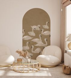 a living room filled with white furniture and lots of birds on the wall behind it