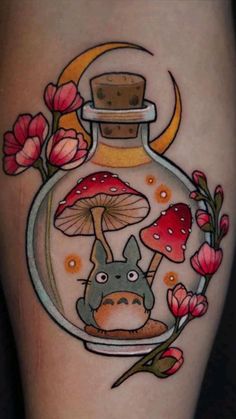 a tattoo with an image of a totoro in a bottle