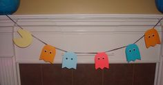 paper ghost garland hanging from a fireplace mantel