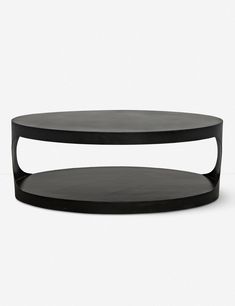 a black coffee table sitting on top of a white floor