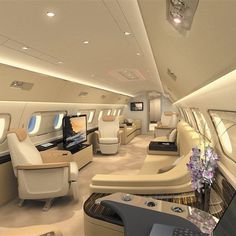 the inside of an airplane with many seats and flowers in vases on the table