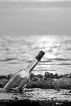 a bottle that is sitting in the sand