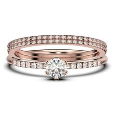 a rose gold wedding ring set with a round diamond in the center and two rows of diamonds on each band