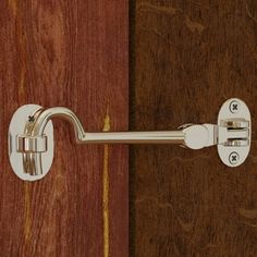 a close up of a door handle on a wooden door