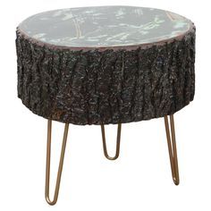 a wooden table with metal legs and a tree stump design on the top is shown