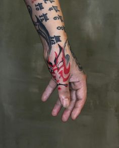 a person with tattoos on their arm and hand