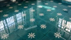 the floor is shiny and has white flowers on it, as well as blue tiles