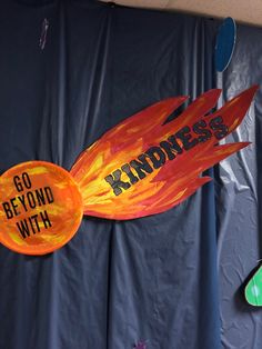 a sign that says, go beyond with kindness and an orange fireball on it