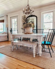 a dining room table with chairs and a bench