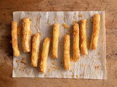 bread sticks are lined up on a piece of parchment paper, ready to be cooked