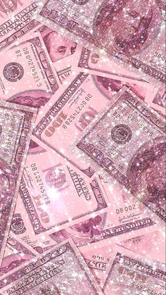 many pink money bills are scattered on top of each other in the air, with sparkles all over them