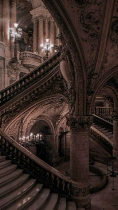 an ornate staircase in a building with chandeliers