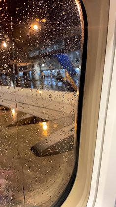 an airplane window with rain drops on it