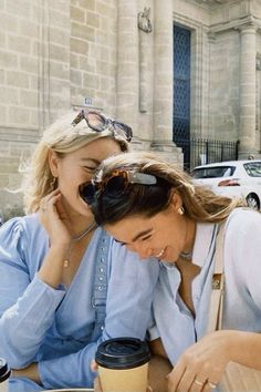 two women sitting at a table with coffee