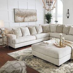 a living room filled with furniture and a chandelier