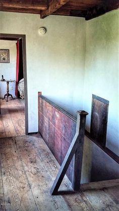 an open door leading to a bedroom with wooden floors