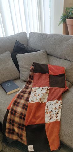 a patchwork blanket sitting on top of a couch