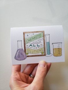 a hand holding up a card with some science related items on it and the words, chemists all about solutions