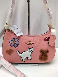 Coach Teri Candy Pink Leather with Creature Patches Crossbody Shoulder Bag 100% authentic New with tag MSRP: $425   Features: Refined pebble leather and Signature coated canvas Two credit card slots Inside multifunction pocket Zip-top closure, fabric lining Detachable handle with 8 1/4" drop Detachable strap with 22 3/4" drop for shoulder or crossbody wear 9 1/2" (L) x 6" (H) x 3" (W) Style No. CC420 Please see the images for further detail and ask any questions you may have before making a bid. Coach Designer Crossbody Shoulder Bag, Designer Coach Crossbody Shoulder Bag, Trendy Coach Shoulder Bag With Double Handle, Designer Coach Shoulder Bag, Coach Leather Pouch Bag, Trendy Coach Shoulder Bag With Top Handle, Trendy Coach Shoulder Bag For Errands, Designer Coach Shoulder Bag For Errands, Pink Coach Leather Shoulder Bag