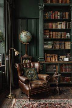 a chair in front of a bookshelf with a globe on top of it