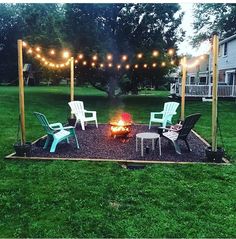 a fire pit surrounded by chairs and lights