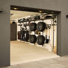 a garage filled with lots of different types of tires and tools hanging on the wall