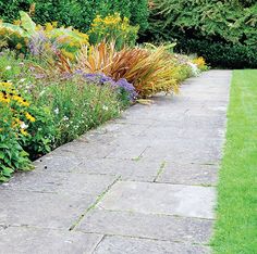 a garden with lots of flowers and plants in it