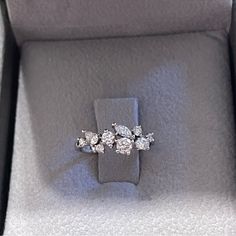 three stone diamond ring sitting in a box