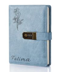 a blue notebook with a flower on the front and writing that says,'falima '