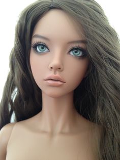 a close up view of a doll with long hair and blue eyes, on a white background