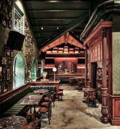 the interior of a restaurant with wooden tables and booths