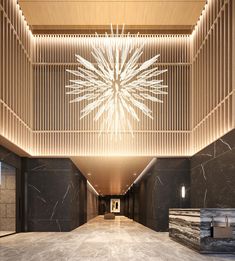 an empty lobby with benches and lights on the ceiling is pictured in this image taken from the ground level