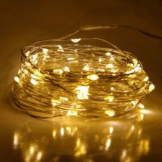 a string of white lights on a table with the light reflecting off of it's surface