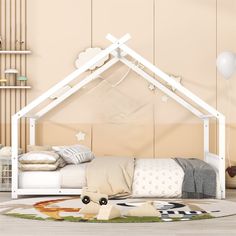 a white bed with a canopy over it in a room filled with furniture and decor