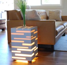 a living room with a couch, table and lamp in it's centerpiece