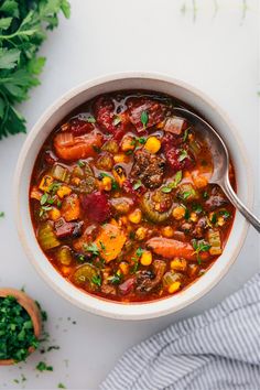 a white bowl filled with stew and vegetables