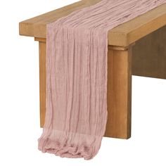 a wooden bench with a pink scarf hanging from it's back end, against a white background