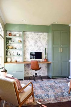 a living room filled with furniture and a flat screen tv on top of a desk