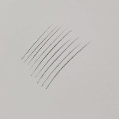 several black and white lines are drawn in the air on a sheet of gray paper