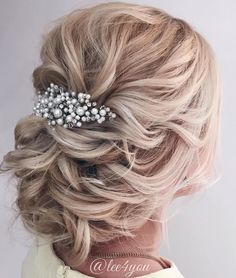 the back of a woman's head wearing a hair comb with pearls on it