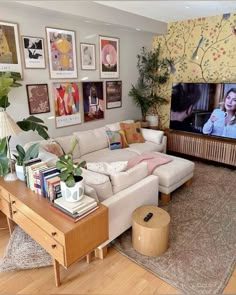 a living room filled with furniture and a flat screen tv mounted to the side of a wall