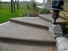 an outdoor area with steps and landscaping in the background