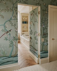 the bathroom is decorated in blue and green with birds on it's wallpaper