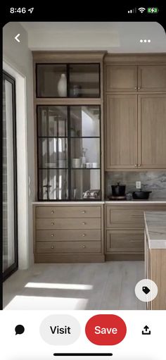 a kitchen with wooden cabinets and marble counter tops