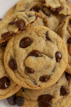 chocolate chip cookies piled on top of each other with one cookie in the middle surrounded by smaller ones