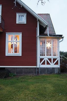 a red house with white trim and windows