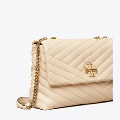 The Kira Convertible Shoulder Bag is made of soft chevron-quilted leather with beveled Double T hardware. An adjustable chain strap adapts in the moment — doubled over the shoulder, or long and crossbody. Kira Chevron Convertible Shoulder Bag, Tory Burch Kira Chevron, Tory Burch Shoulder Bag, Kira Chevron, Clothes Making, Tory Burch Kira, Women's Suiting, Womens Designer Handbags, Leather Roll